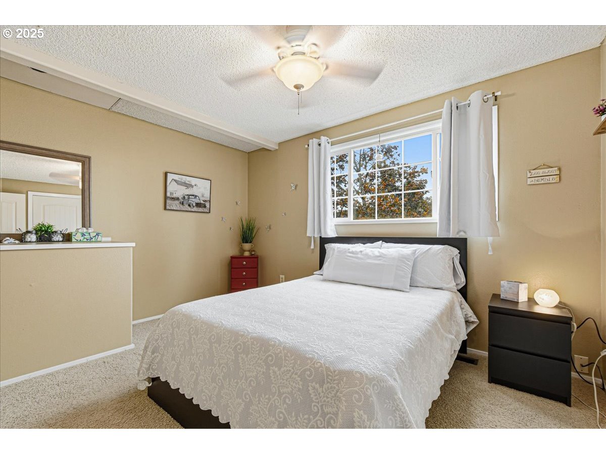 1820 Southwest Heiney Road Gresham, OR 97080 - Photo 32 of 48 a bedroom with a bed and a painting on the wall