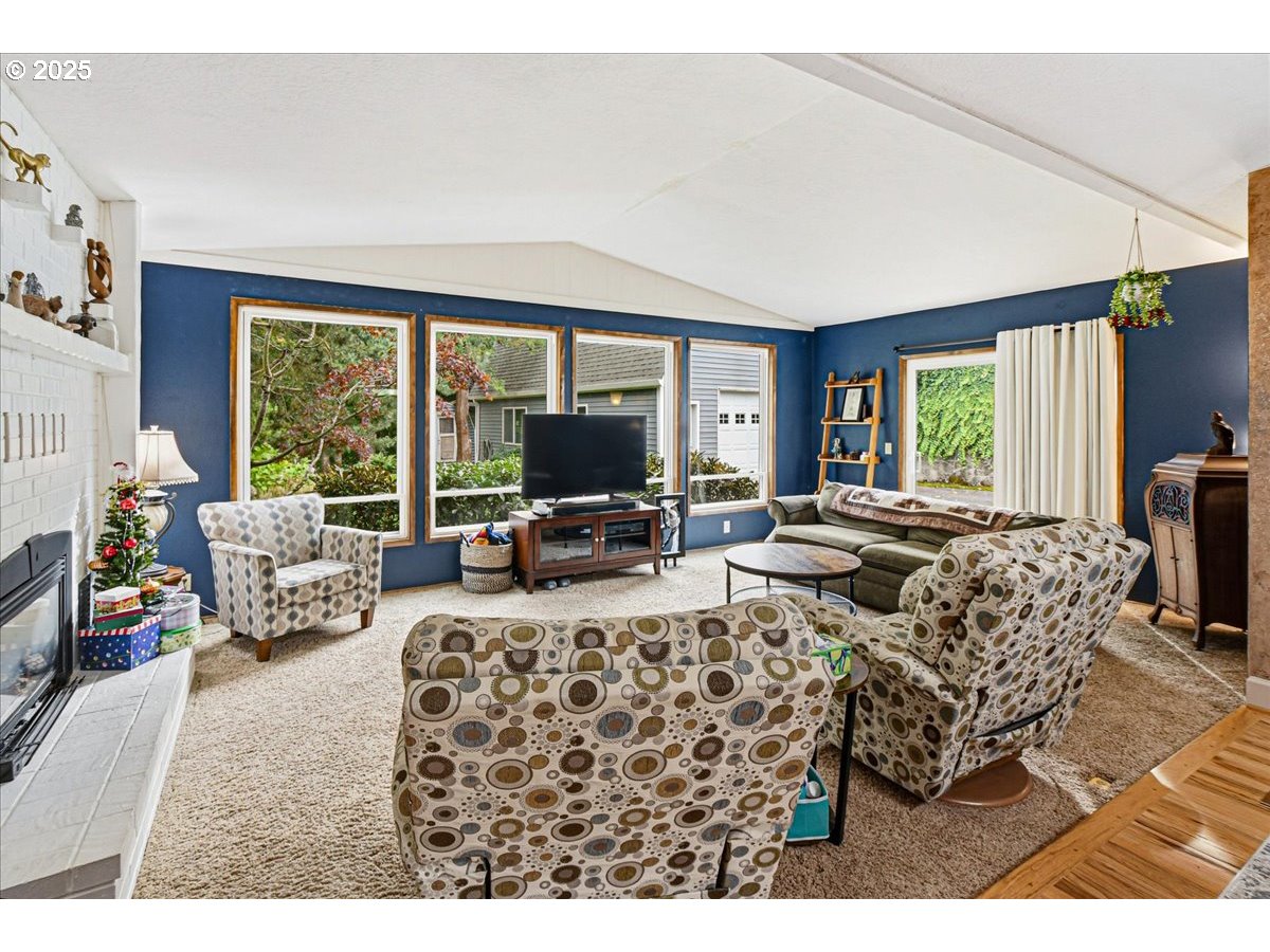 1820 Southwest Heiney Road Gresham, OR 97080 - Photo 6 of 48 a living room with furniture large window and a flat screen tv