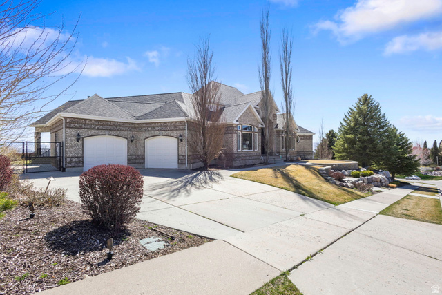 684 North Summit Way Alpine, UT 84004 - Photo 9 of 58 View of front of house with concrete driveway, a garage, a shingled roof, brick siding, and a gate