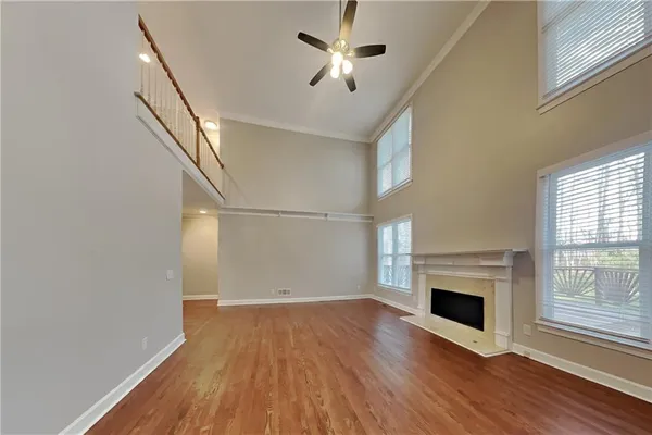 a view of empty room with wooden floor and fireplace