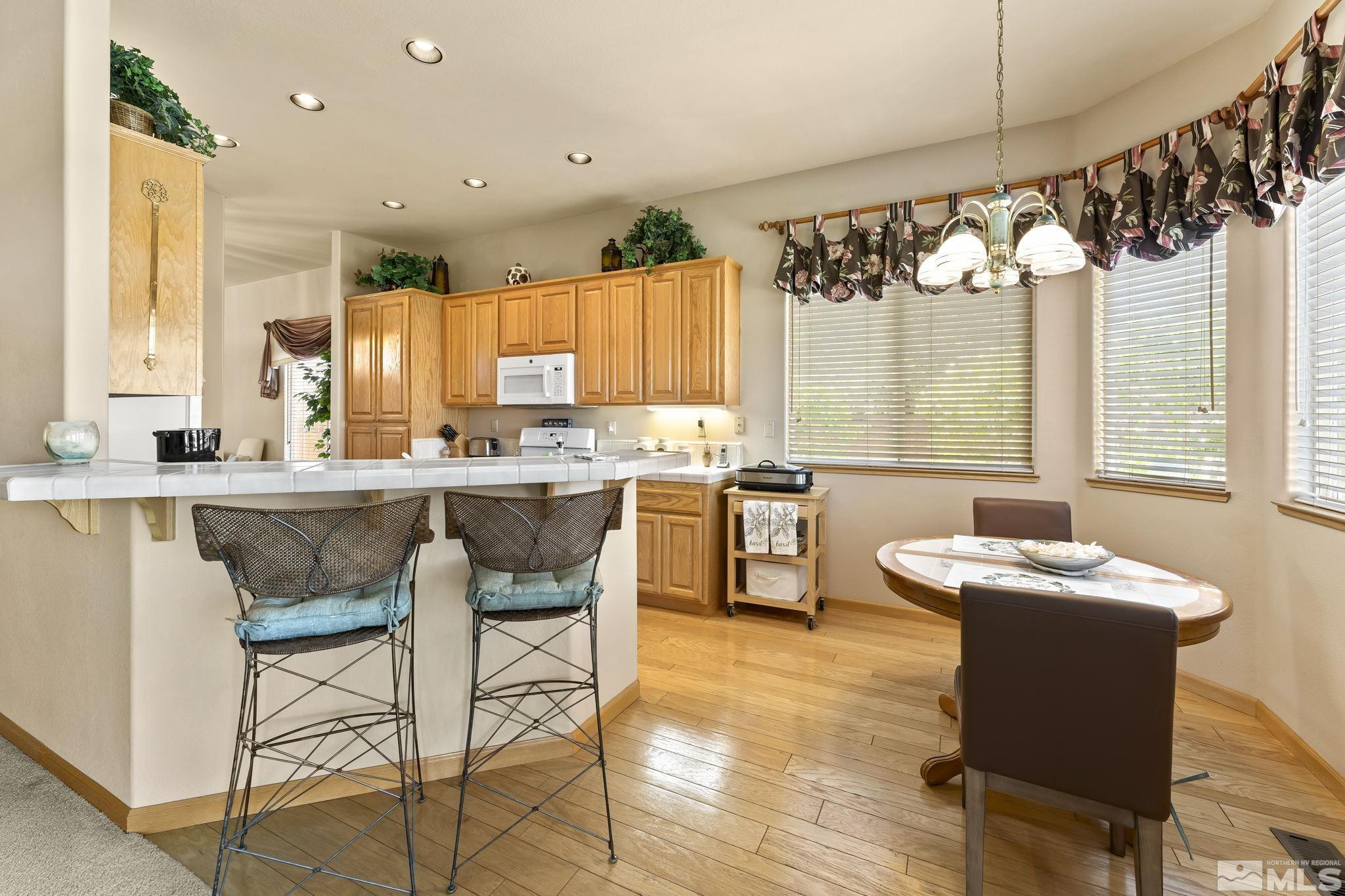 1021 University Place Reno, NV 89512 - Photo 14 of 40 a kitchen with a table chairs sink and cabinets