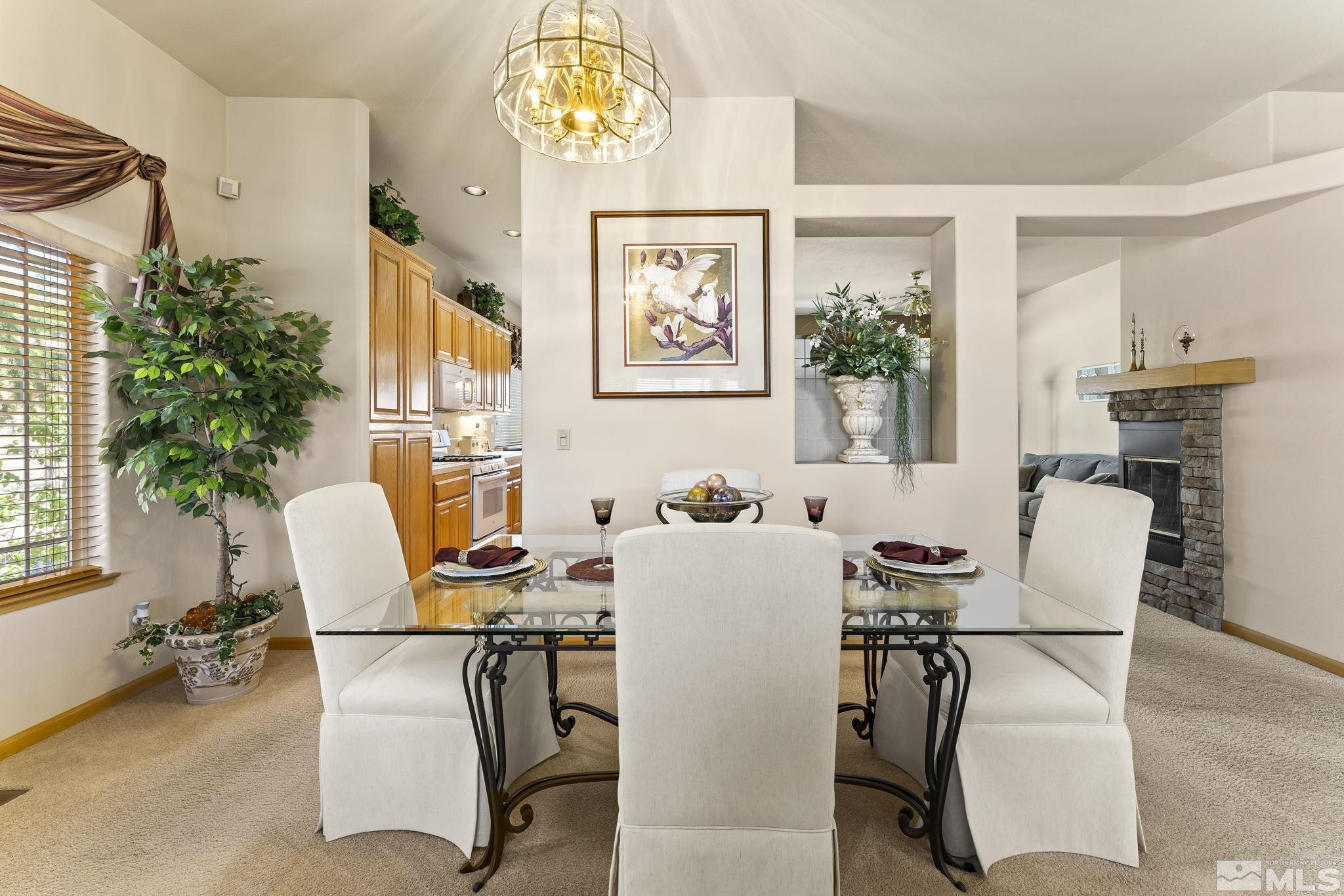 1021 University Place Reno, NV 89512 - Photo 7 of 40 a view of a dining room with furniture and a potted plant