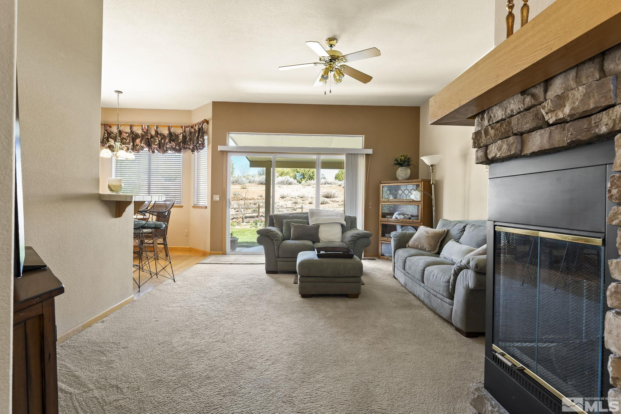 1021 University Place Reno, NV 89512 - Photo 10 of 40 a living room with furniture and a large window