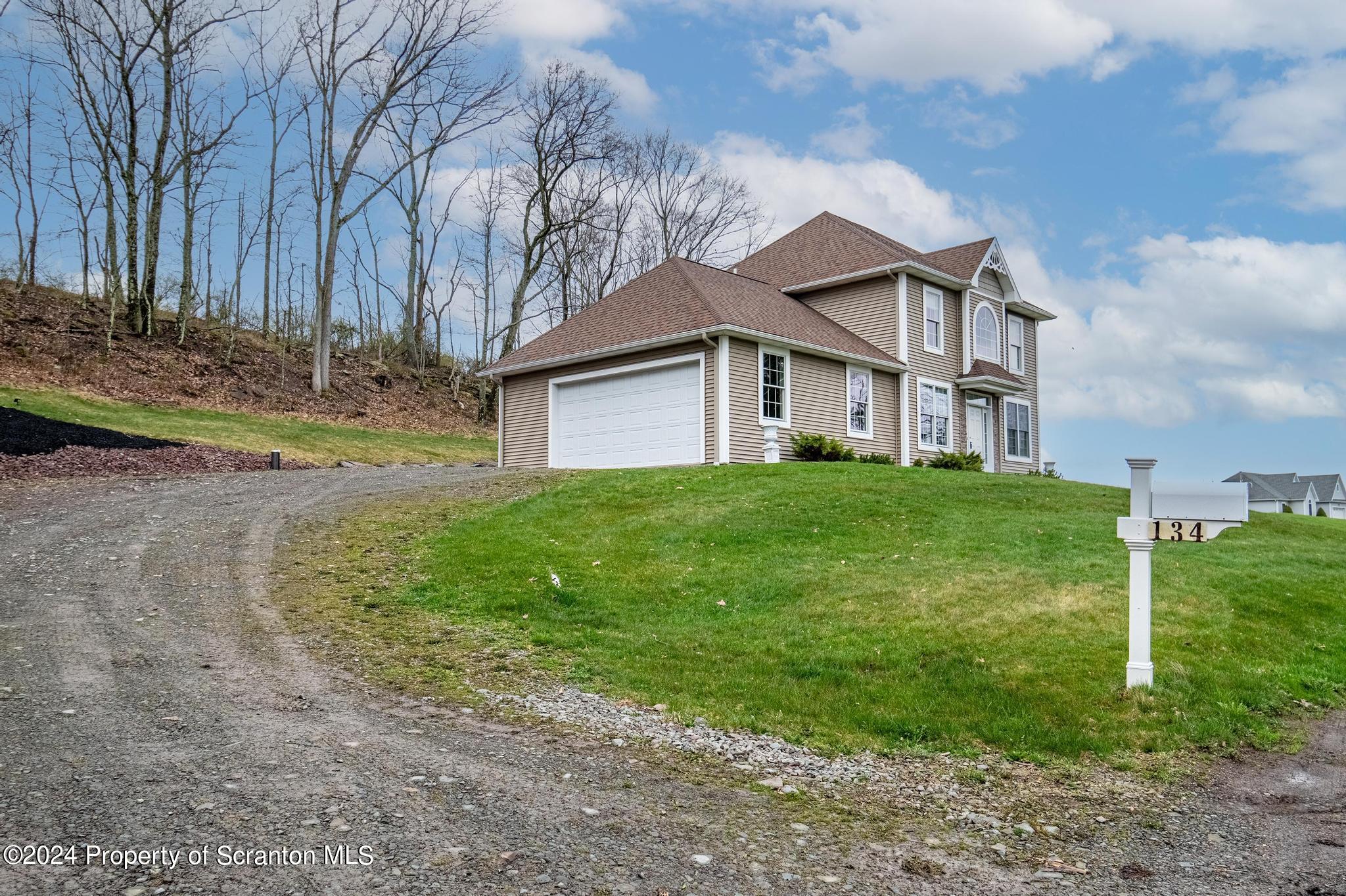 134 Rails Road Tunkhannock, PA 18657 - Photo 5 of 44 a view of a white house with a big yard and large trees