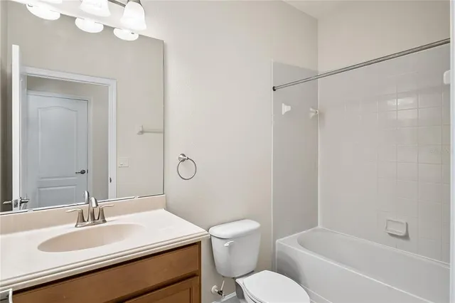 a bathroom with a sink toilet vanity and shower