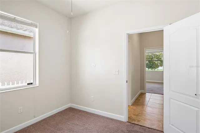 an empty room with wooden floor and a window