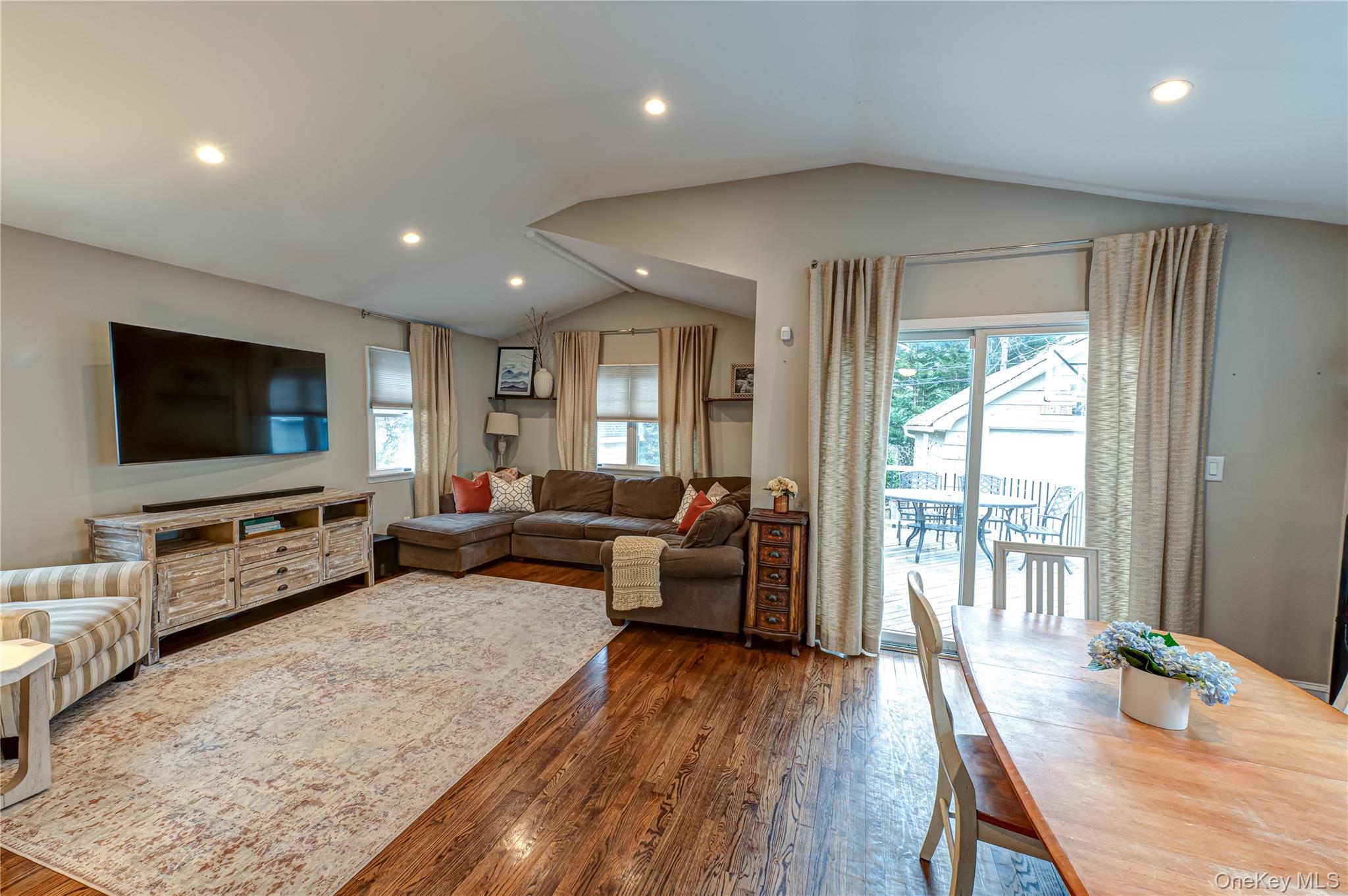 75 Bar Beach Road Port Washington, NY 11050 - Photo 11 of 30 a living room with furniture and a flat screen tv