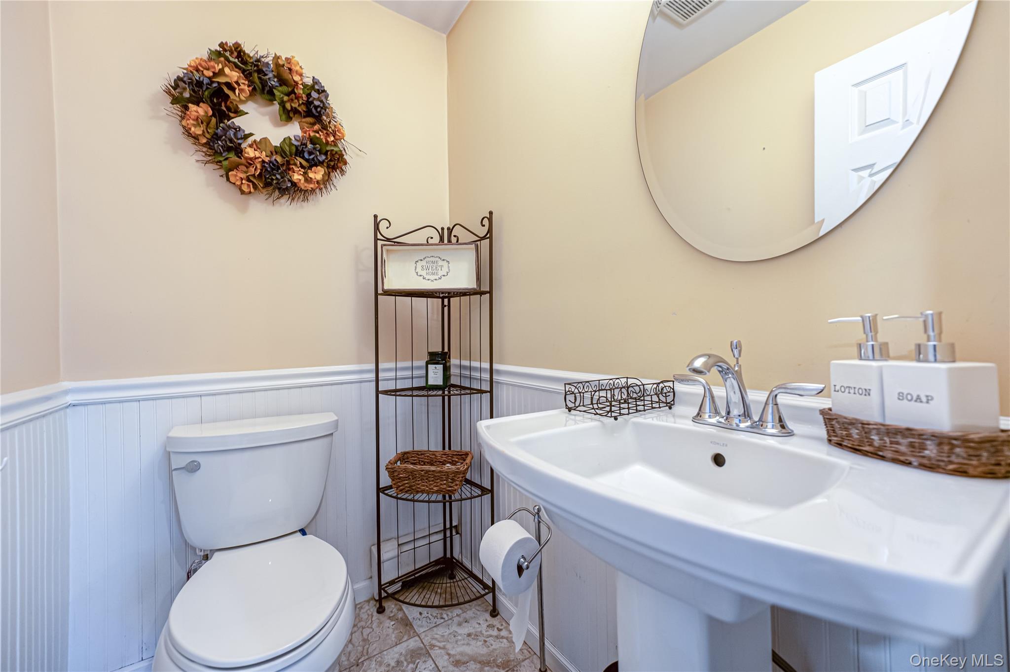 75 Bar Beach Road Port Washington, NY 11050 - Photo 17 of 30 a bathroom with a toilet sink and mirror