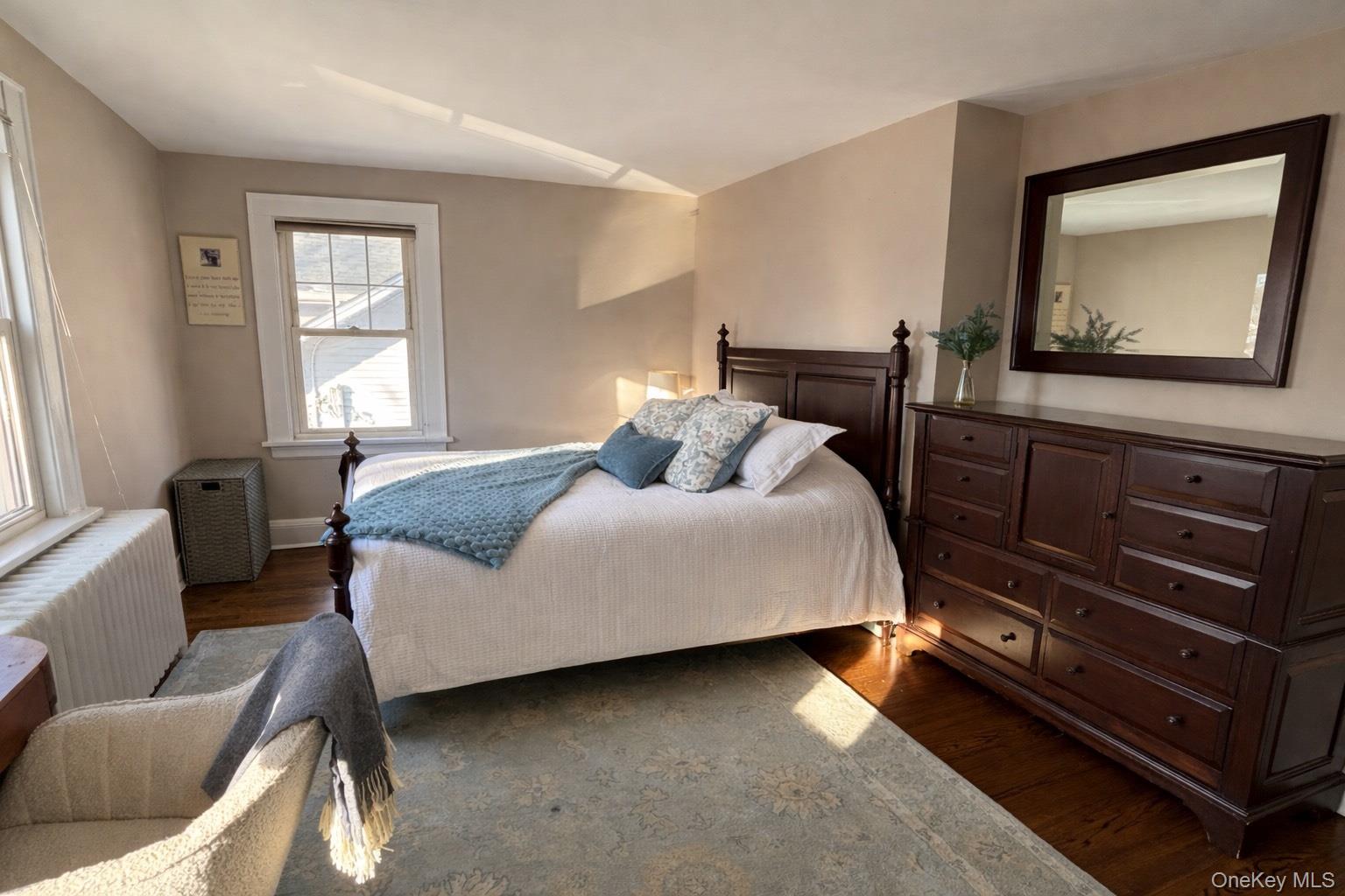 75 Bar Beach Road Port Washington, NY 11050 - Photo 19 of 30 a bedroom with a bed and wooden floor