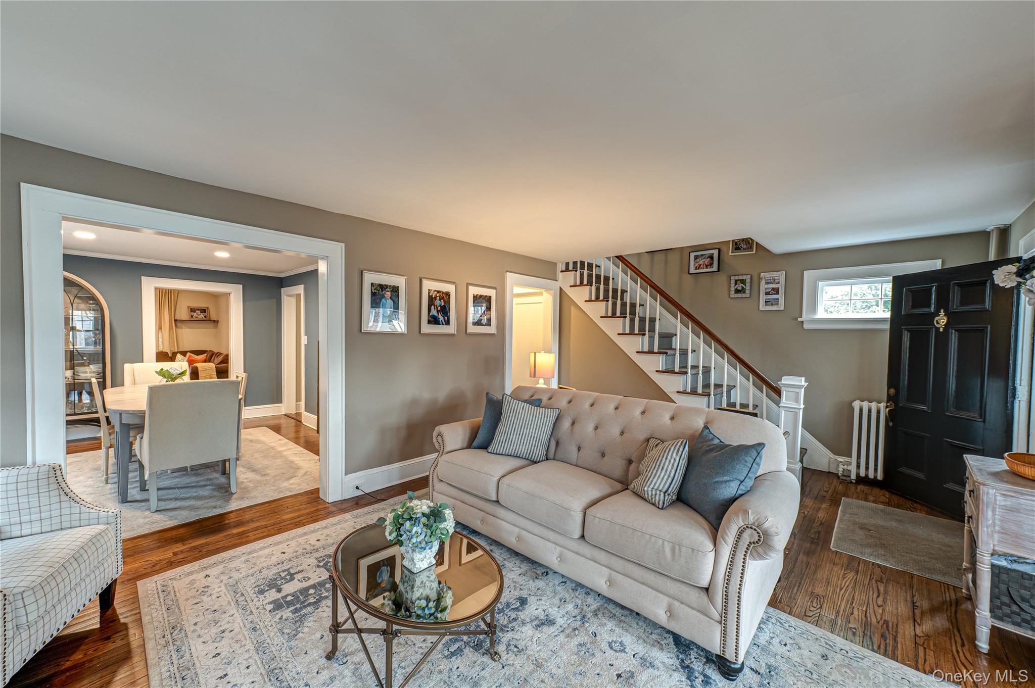 75 Bar Beach Road Port Washington, NY 11050 - Photo 2 of 30 a living room with furniture kitchen view and a wooden floor