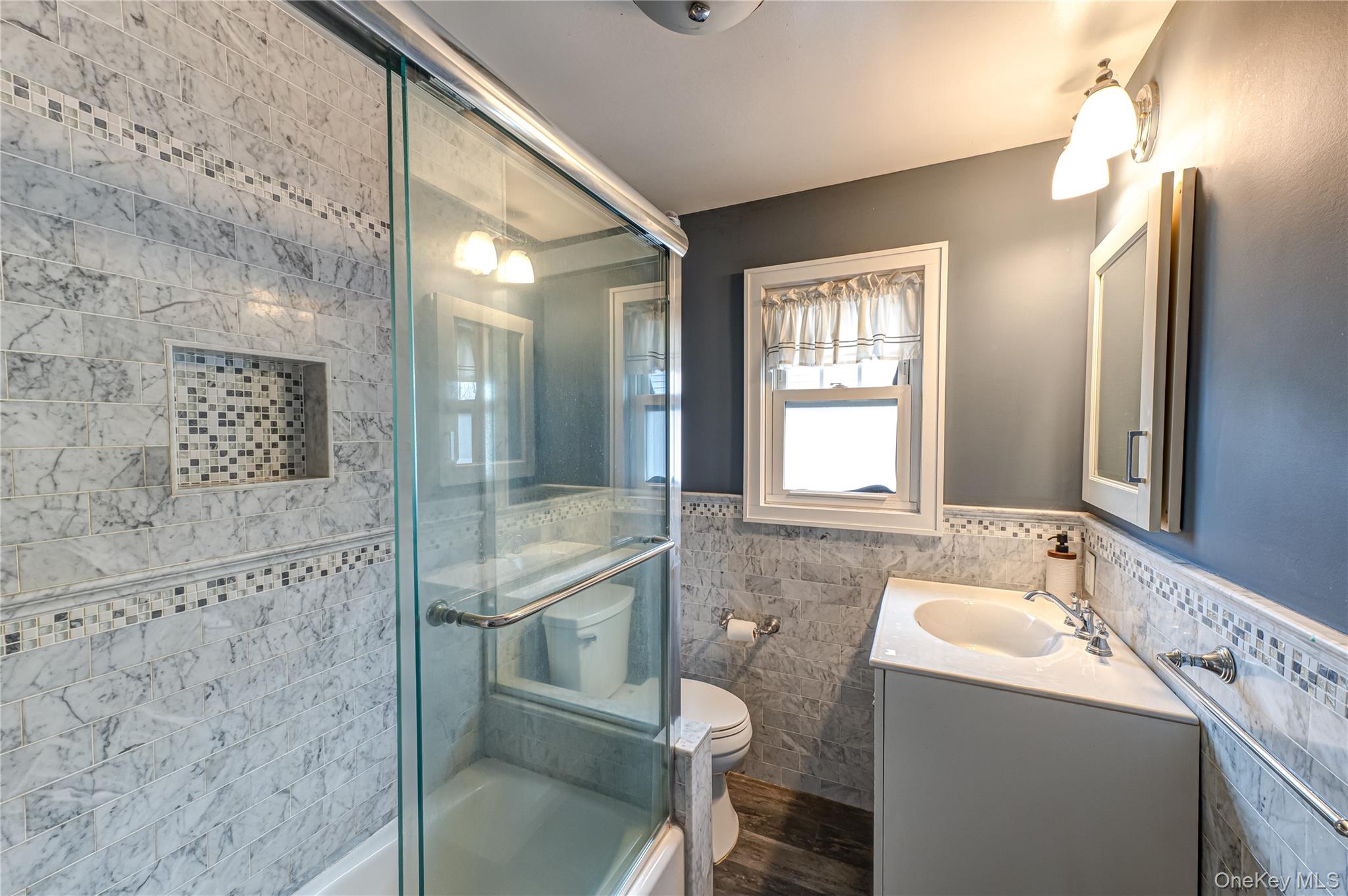 75 Bar Beach Road Port Washington, NY 11050 - Photo 22 of 30 a bathroom with a sink mirror and a shower