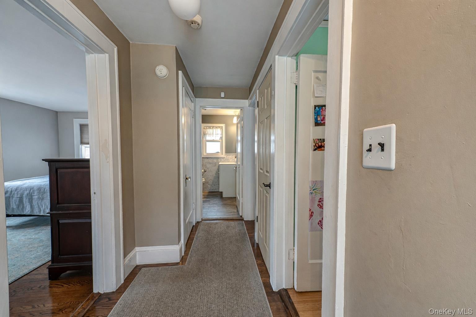 75 Bar Beach Road Port Washington, NY 11050 - Photo 23 of 30 a view of a hallway with wooden floor and a bathroom