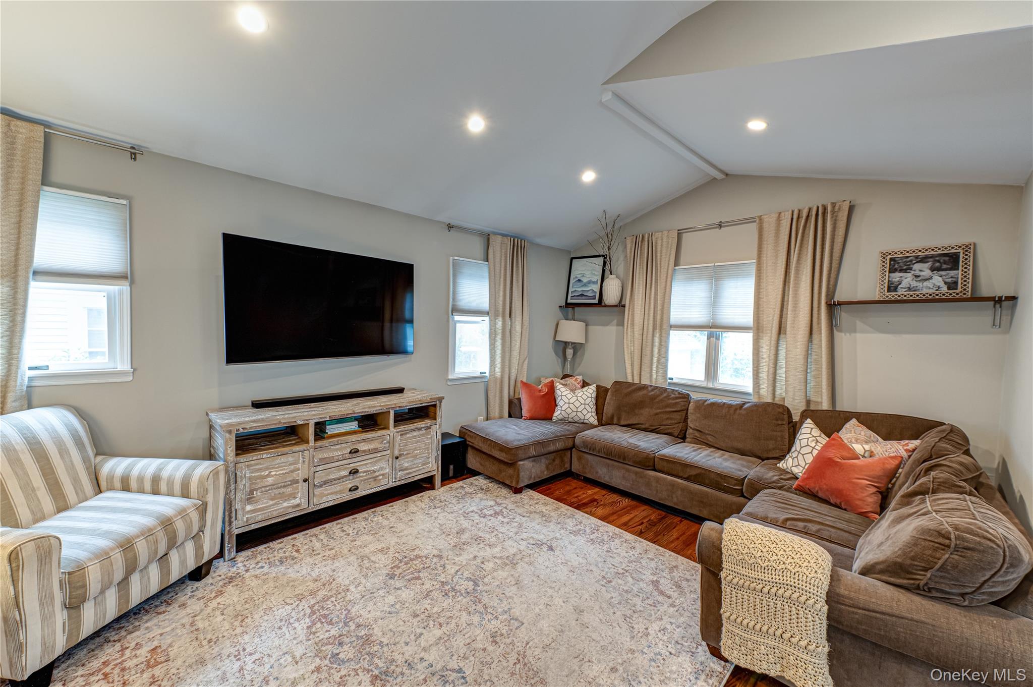 75 Bar Beach Road Port Washington, NY 11050 - Photo 3 of 30 a living room with furniture and a flat screen tv
