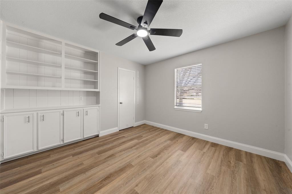 1312 Crow Drive Waco, TX 76705 - Photo 12 of 22 wooden floor in an empty room with a window