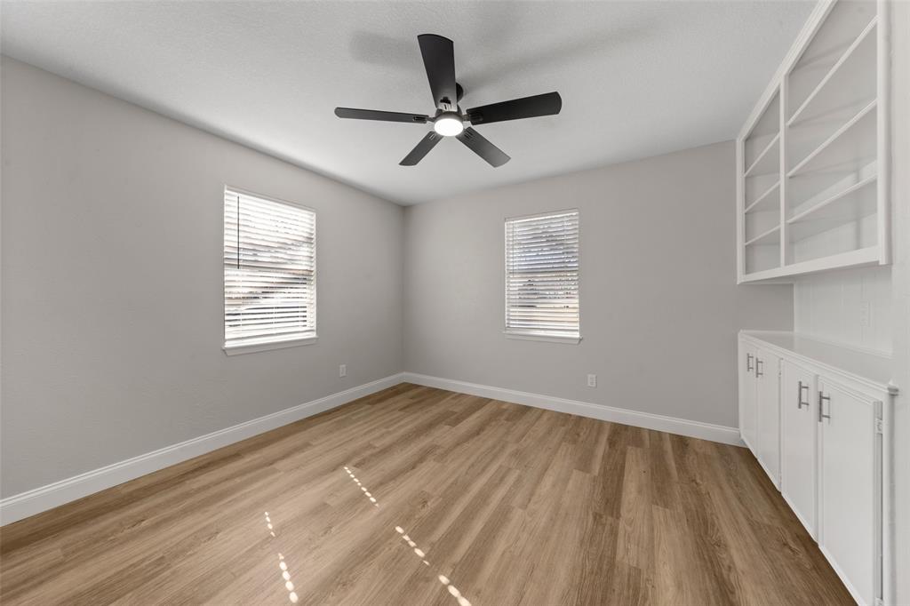 1312 Crow Drive Waco, TX 76705 - Photo 14 of 22 a view of empty room with wooden floor and fan