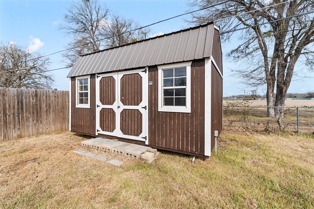 1312 Crow Drive Waco, TX 76705 - Photo 18 of 22 a view of a house with a door and wooden fence