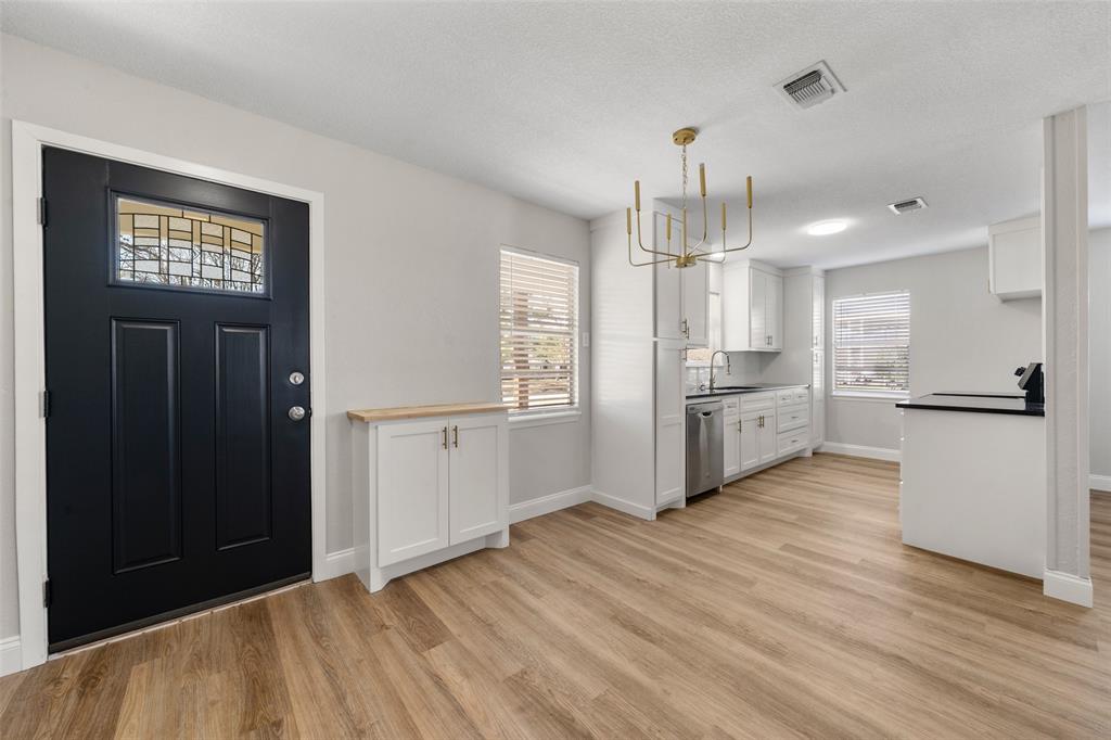 1312 Crow Drive Waco, TX 76705 - Photo 2 of 22 a view of a kitchen with refrigerator and wooden floor