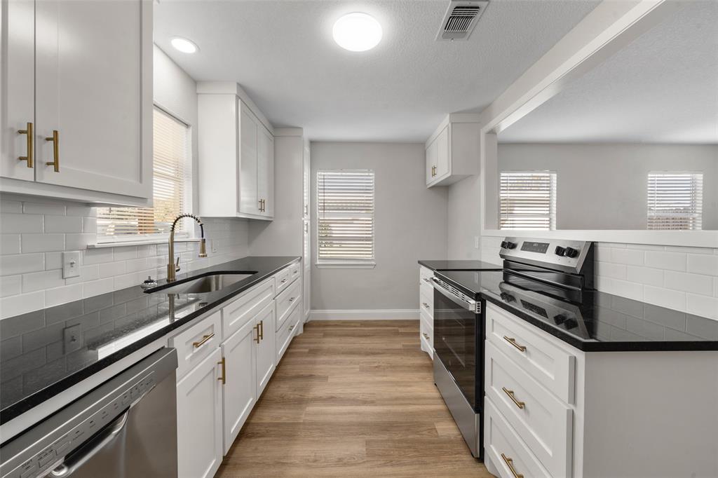 1312 Crow Drive Waco, TX 76705 - Photo 4 of 22 a kitchen with granite countertop stainless steel appliances and cabinets