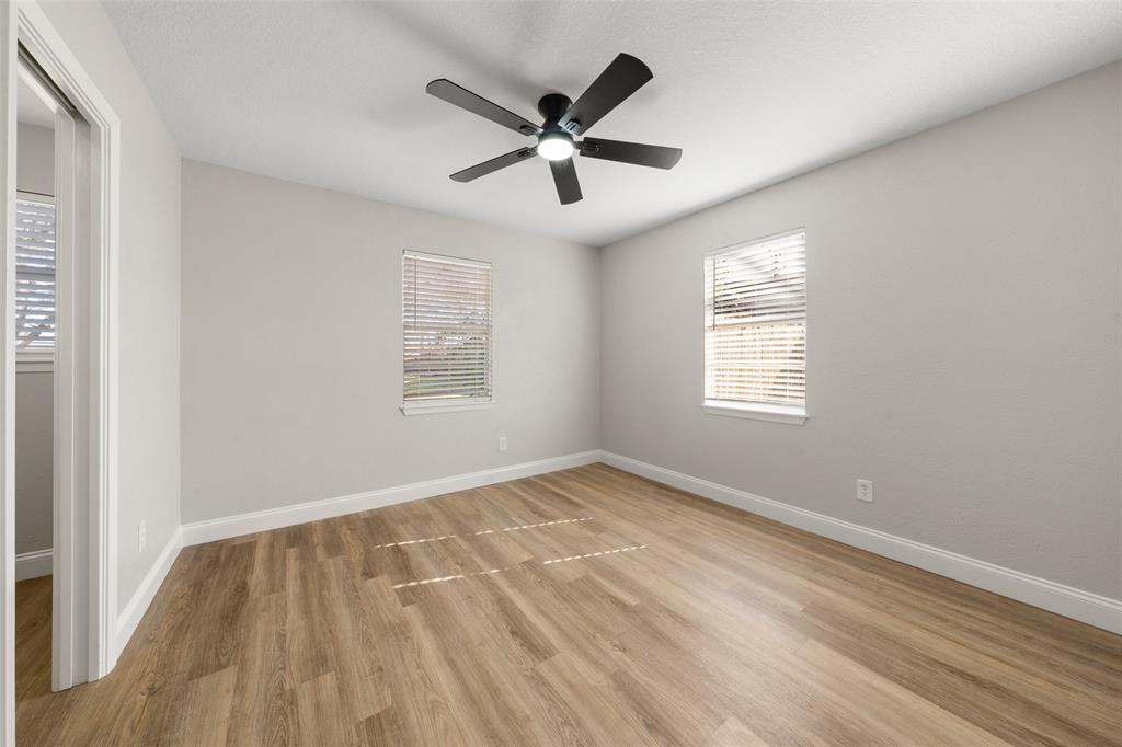 1312 Crow Drive Waco, TX 76705 - Photo 8 of 22 a view of an empty room with wooden floor and a window