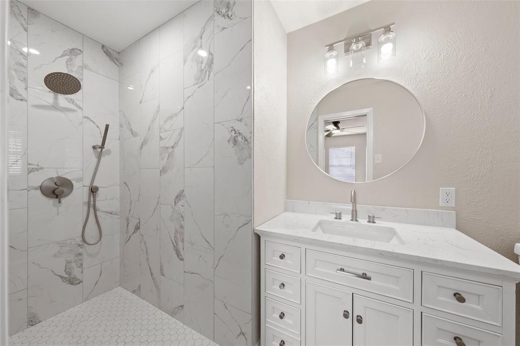 1312 Crow Drive Waco, TX 76705 - Photo 10 of 22 a bathroom with a shower a sink and mirror