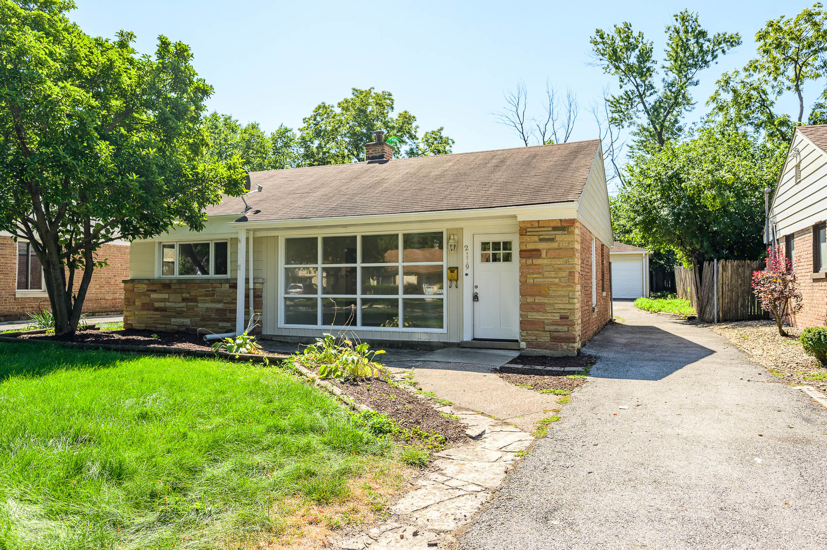 2119 Hawthorne Road Homewood, IL 60430 - Photo 1 of 9 a front view of a house with a yard and garage