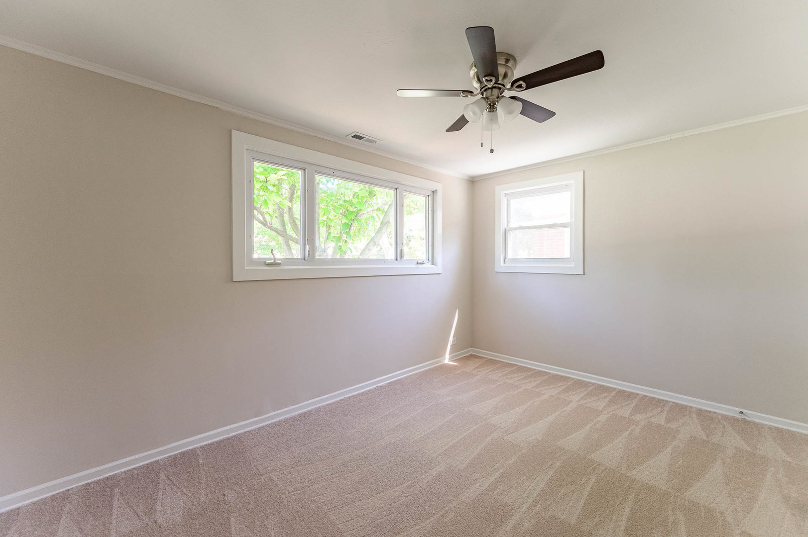 2119 Hawthorne Road Homewood, IL 60430 - Photo 4 of 9 a view of a livingroom with a ceiling fan & windows