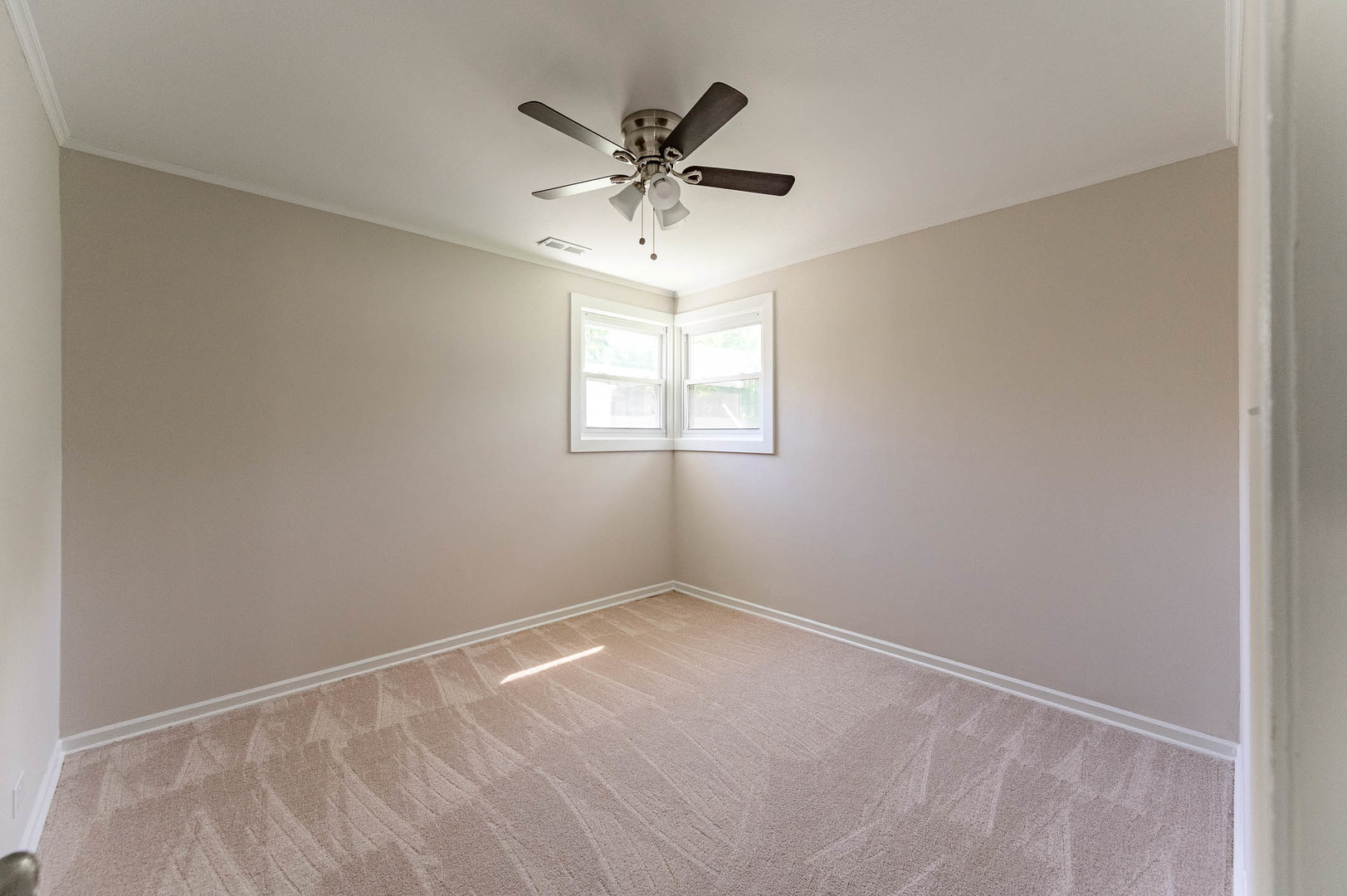 2119 Hawthorne Road Homewood, IL 60430 - Photo 5 of 9 an empty room with a window and a fan