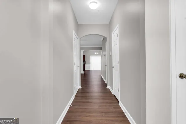 a view of a hallway with a wooden floor