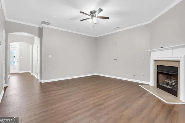 wooden floor in an empty room with a fireplace