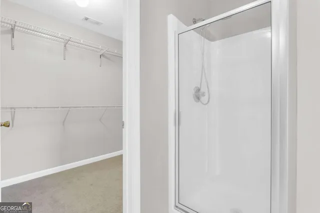 a bathroom with a glass shower door