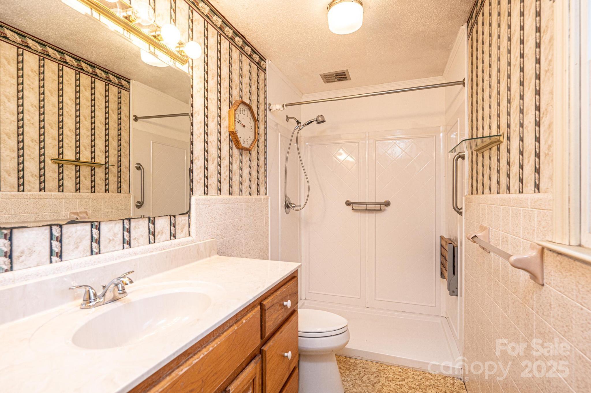 6000 George Hildebran School Road Hickory, NC 28602 - Photo 11 of 21 a bathroom with a sink toilet and shower
