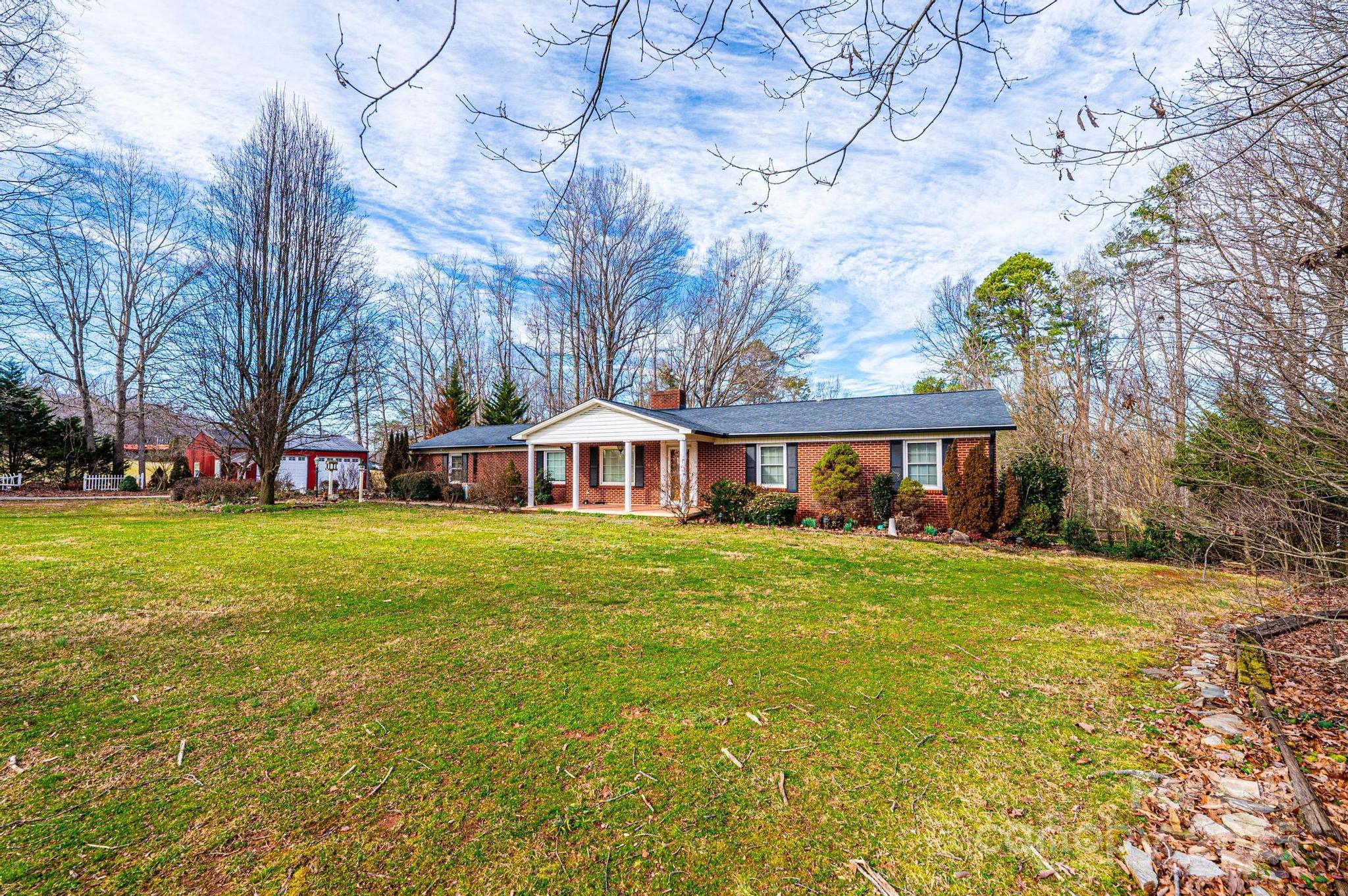 6000 George Hildebran School Road Hickory, NC 28602 - Photo 13 of 21 a front view of a house with a garden