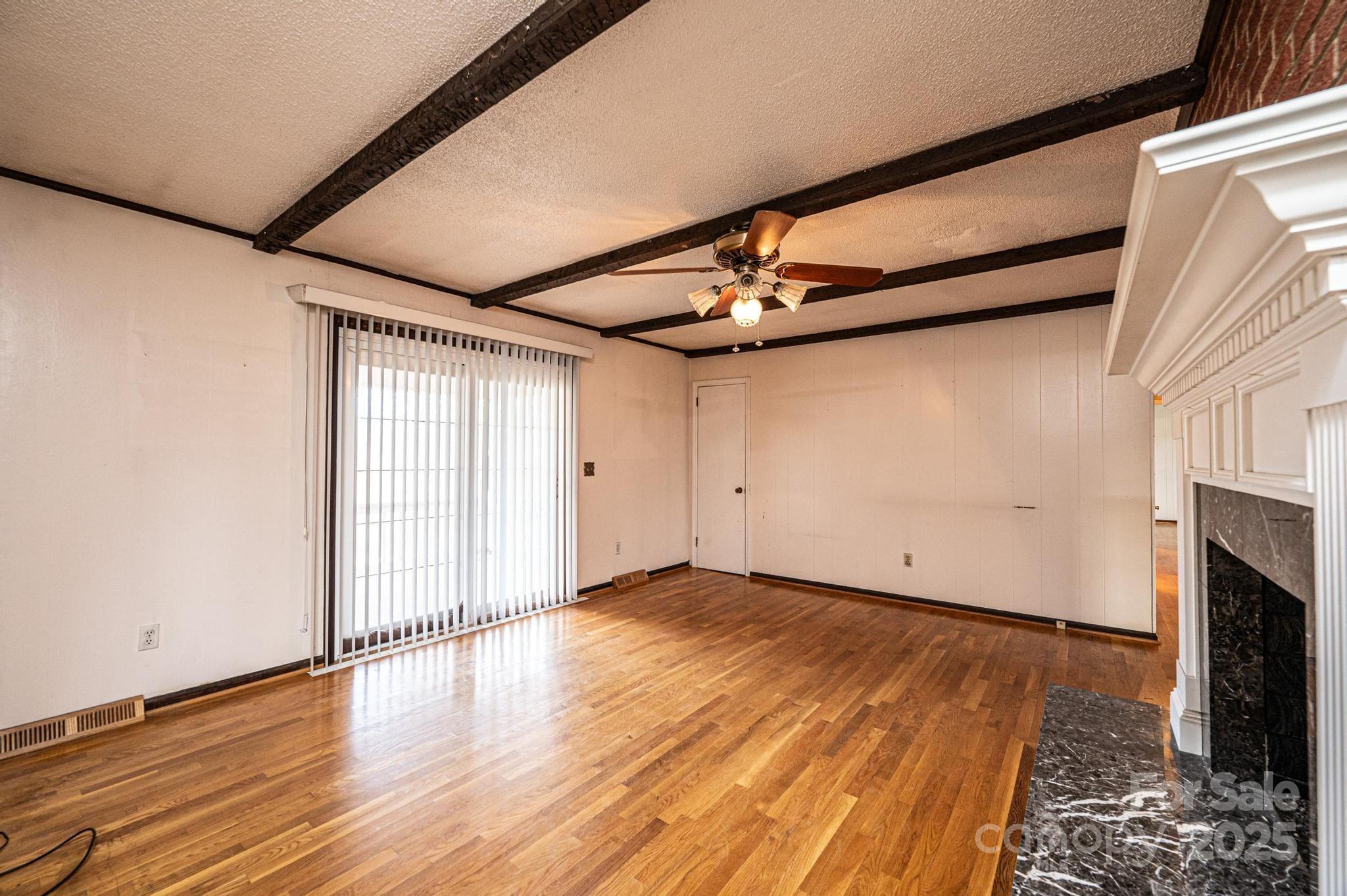 6000 George Hildebran School Road Hickory, NC 28602 - Photo 5 of 21 a view of an empty room with wooden floor and a window