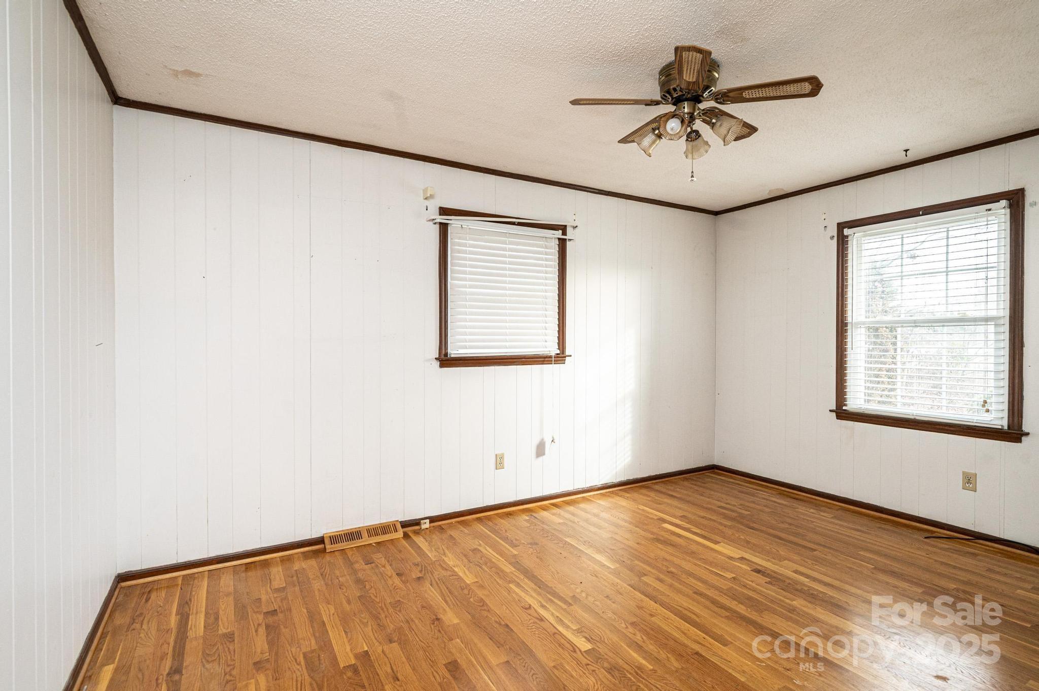 6000 George Hildebran School Road Hickory, NC 28602 - Photo 8 of 21 an empty room with a window and a ceiling fan