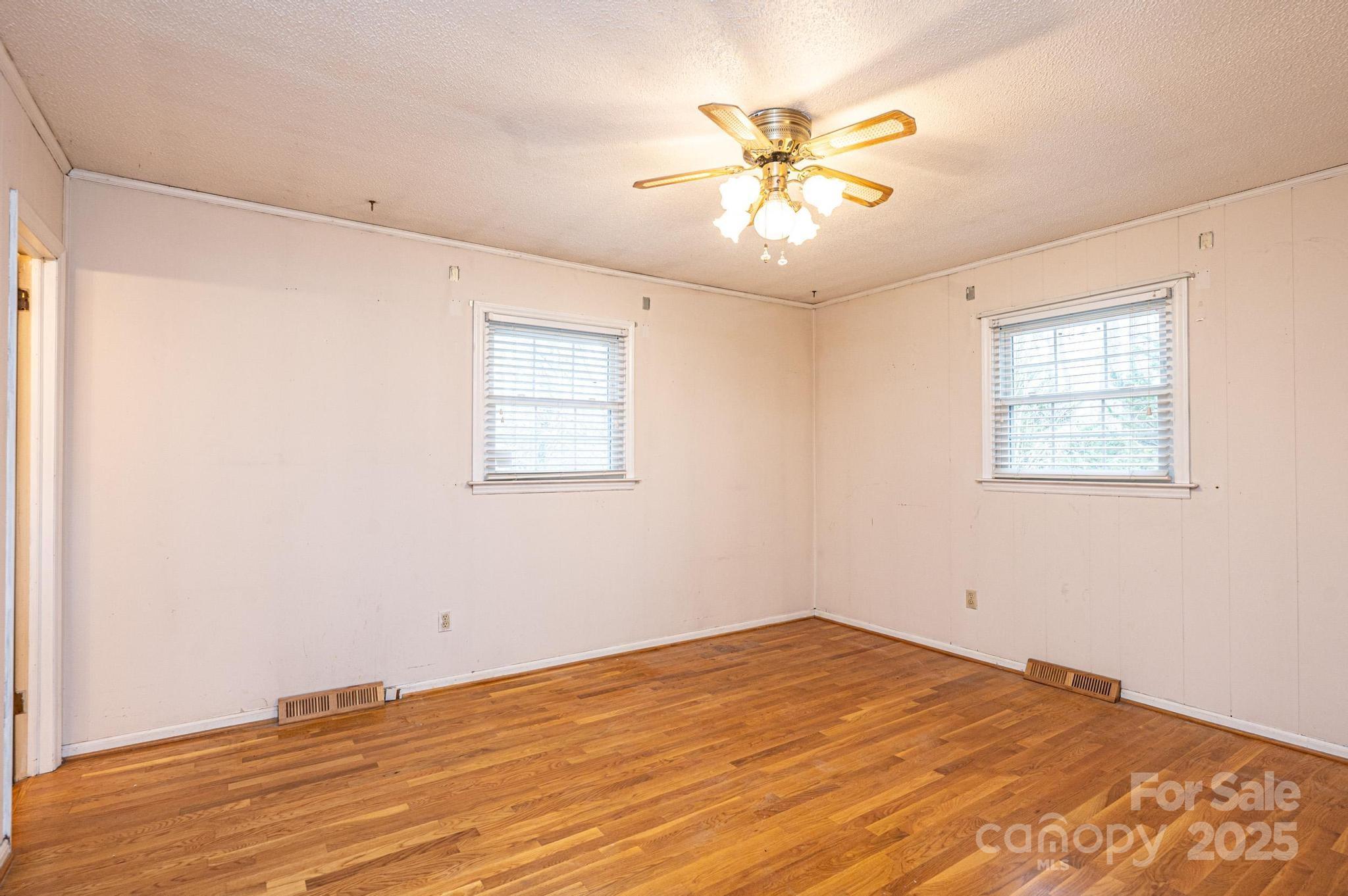 6000 George Hildebran School Road Hickory, NC 28602 - Photo 9 of 21 a view of a room with wooden floor and chandelier fan