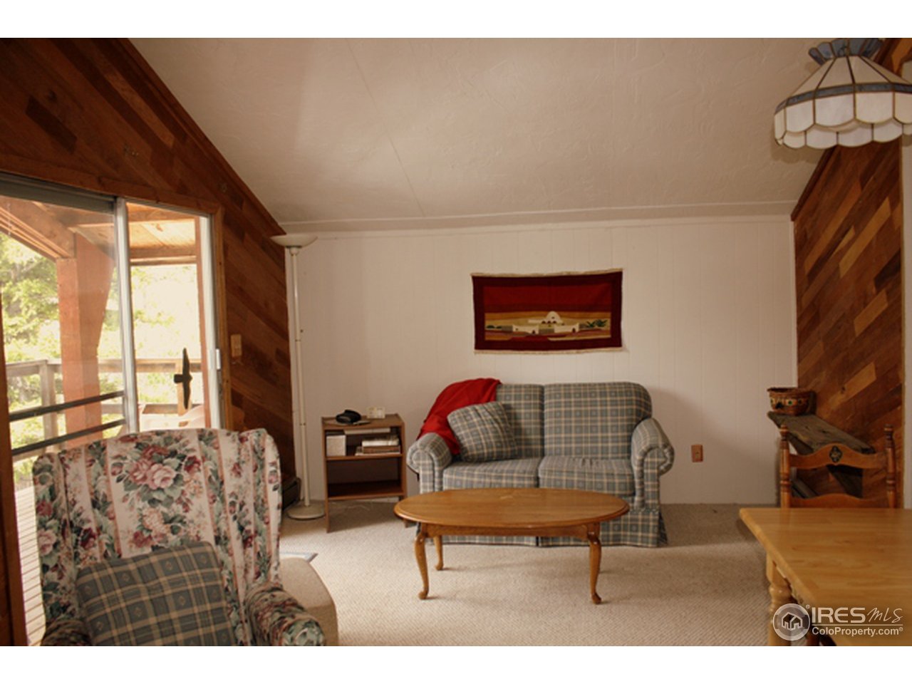 368 Shawnee Road Red Feather Lakes, CO 80545 - Photo 8 of 14 living room-sliding doors lead to covered deck