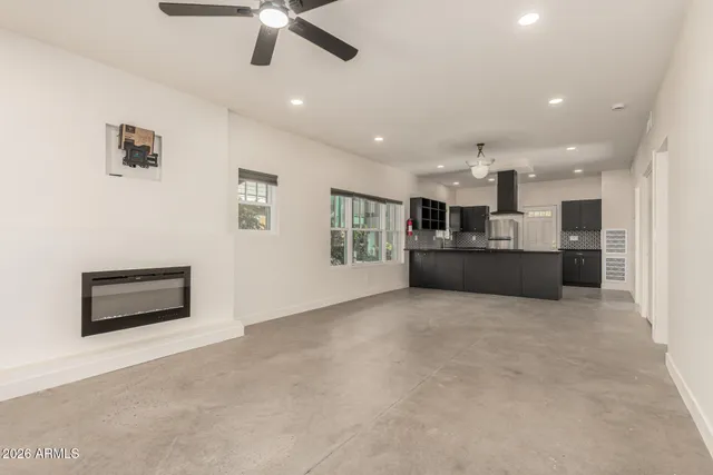 a living room with stainless steel appliances kitchen island furniture and a kitchen view