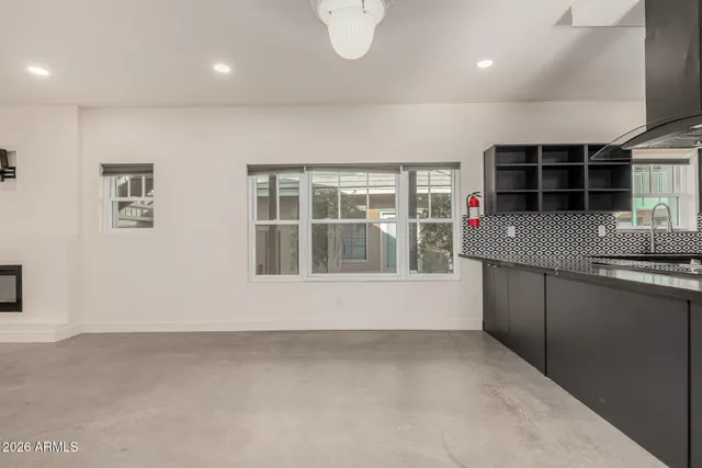 an empty room with a window and fireplace