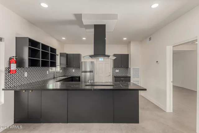 a kitchen with kitchen island granite countertop a sink and counter space