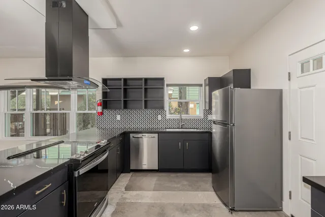 a kitchen with stainless steel appliances granite countertop a refrigerator and a sink