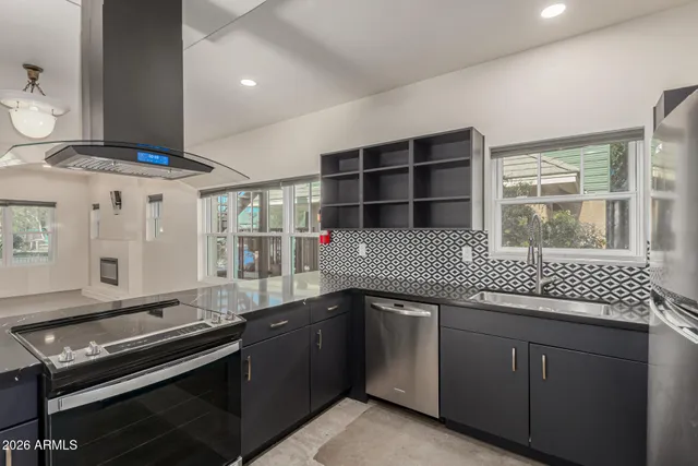 a kitchen with a sink stove and cabinets
