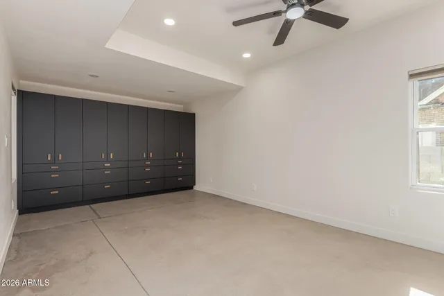 an empty room with a cabinet and mirrors