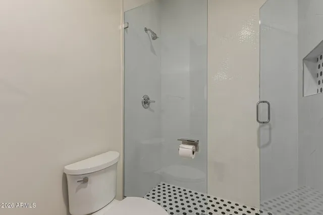 a bathroom with a toilet and shower