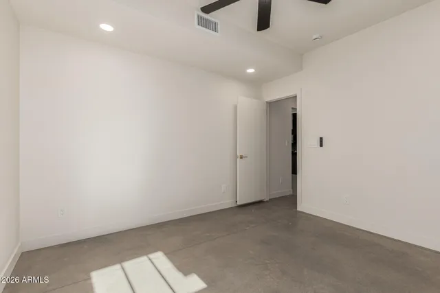 an empty room with projector and windows