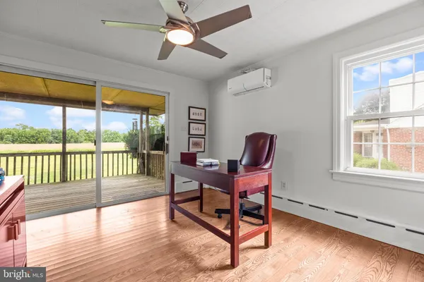 a reading room with furniture and a large window