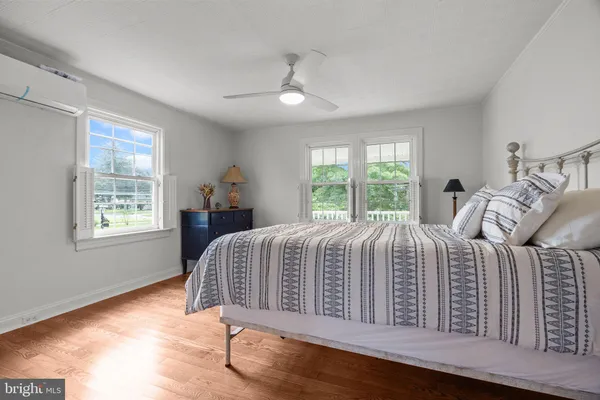 a bed sitting in a bedroom next to a window