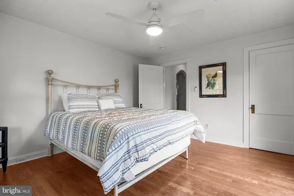 a bedroom with a bed and painting on the wall