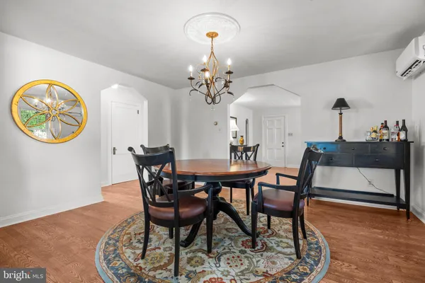 a view of a dining room with furniture and chandelier