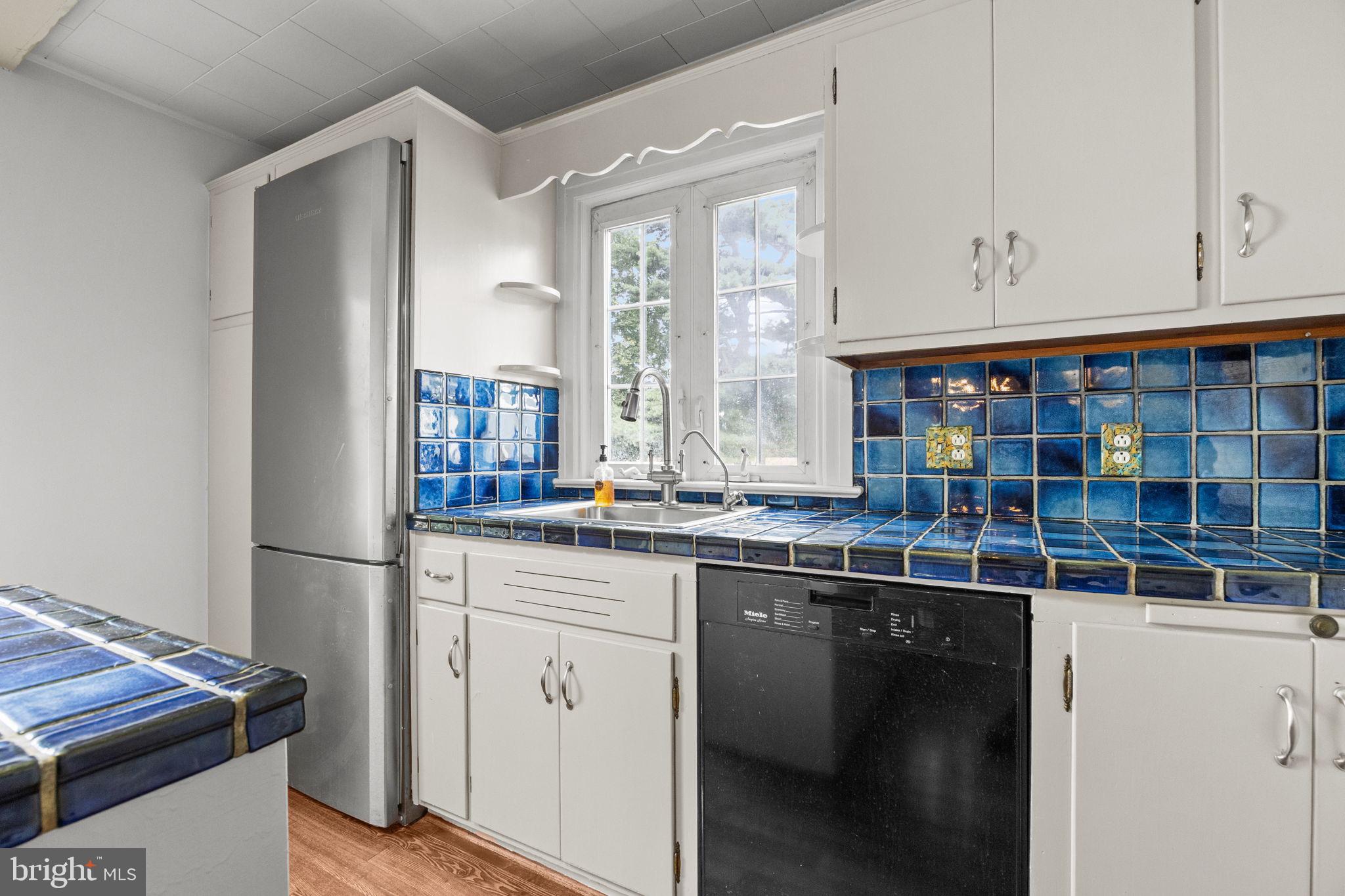 182 West Upper Ferry Ewing, NJ 08628 - Photo 10 of 33 Charming kitchen with vibrant blue tiles.