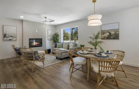 a view of a dining room with furniture wooden floor and chandelier